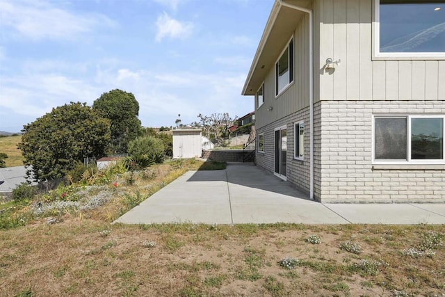5884 Redondo Dr, Bonsall, CA 92003 - view of side of home with a patio area and brick siding