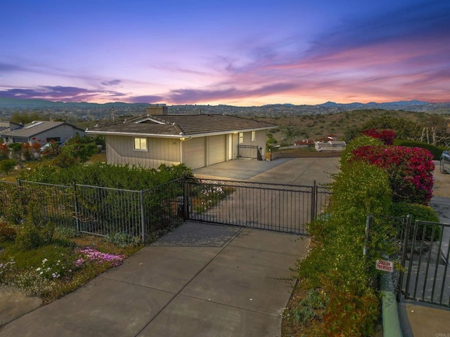 5884 Redondo Dr, Bonsall, CA 92003 - single story home with a gate, concrete driveway, a mountain view, and an attached garage