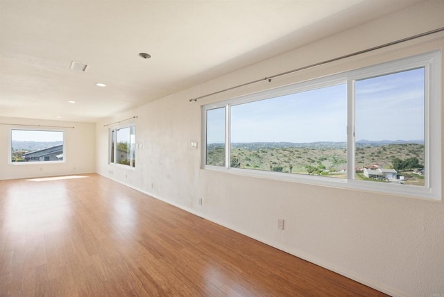 5884 Redondo Dr, Bonsall, CA 92003 - empty room with wood finished floors, baseboards, and recessed lighting