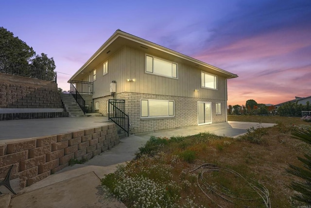 5884 Redondo Dr, Bonsall, CA 92003 - view of side of property with stairs, brick siding, and a patio
