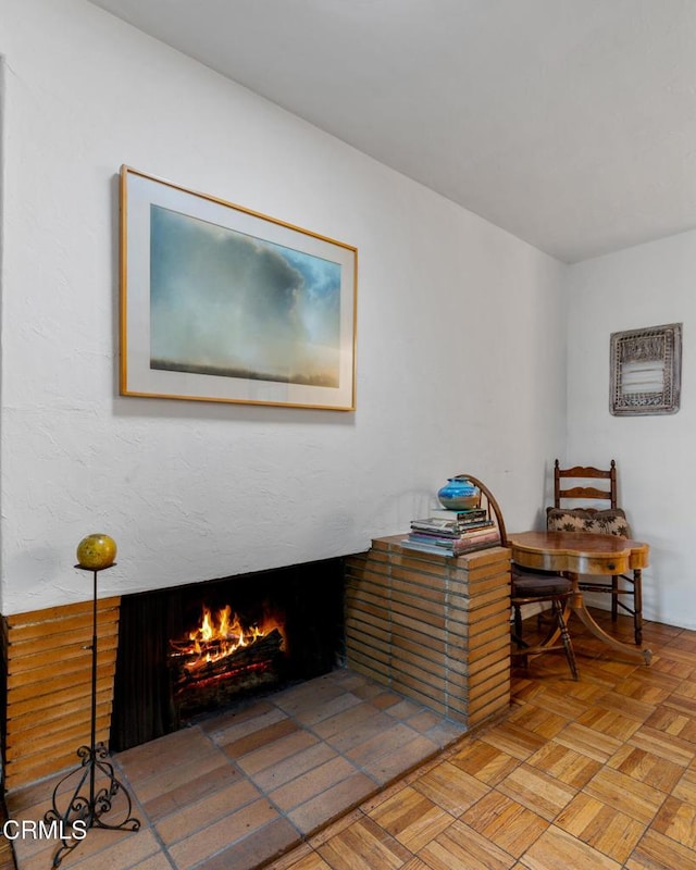 living area featuring a lit fireplace