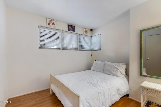 bedroom with wood finished floors