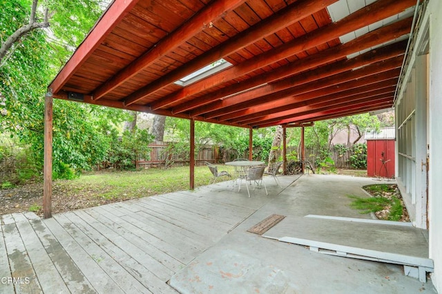 wooden deck featuring a lawn, a fenced backyard, a patio area, and outdoor dining space