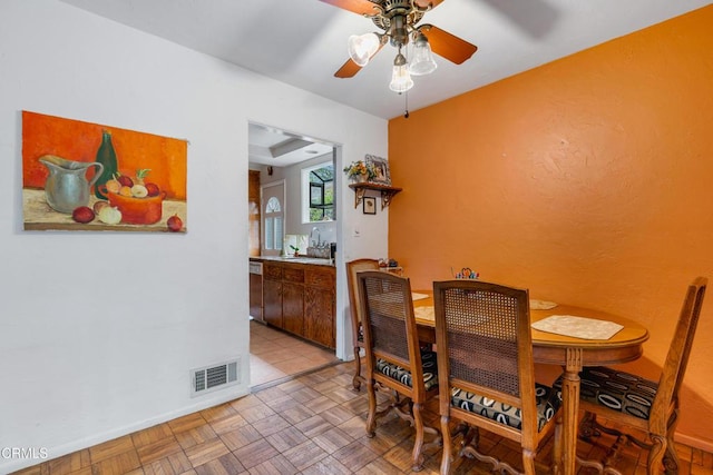 dining room featuring a ceiling fan and visible vents