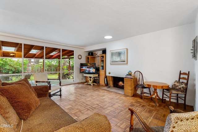 living area with a brick fireplace and recessed lighting
