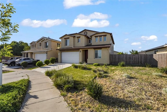 traditional home with a garage, fence, stucco siding, and concrete driveway