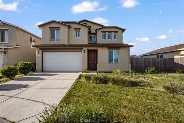 traditional-style house featuring a garage, a front lawn, fence, stucco siding, and driveway