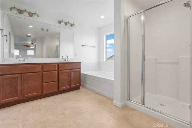full bath featuring a sink, double vanity, a shower stall, and a bath