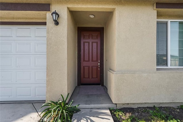 entrance to property featuring stucco siding