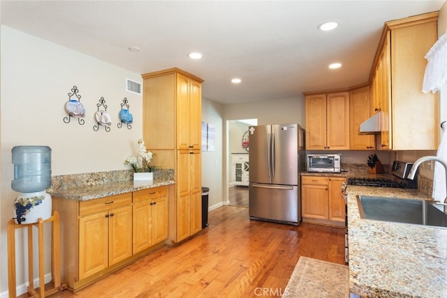 1452 Granada, Corona, CA 92878 - kitchen with appliances with stainless steel finishes, under cabinet range hood, light wood finished floors, recessed lighting, and baseboards