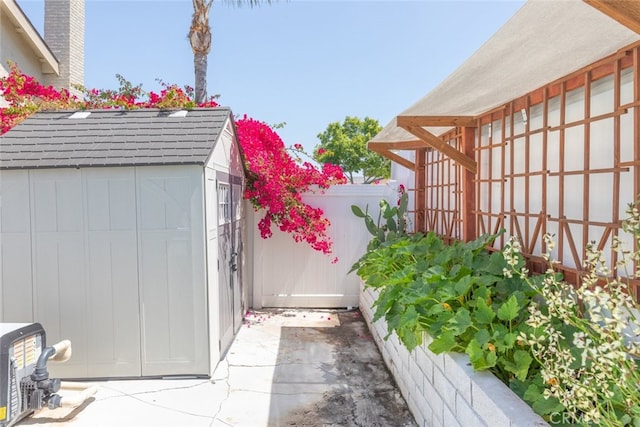 1452 Granada, Corona, CA 92878 - view of home's exterior featuring a shed, an outdoor structure, fence, and roof with shingles