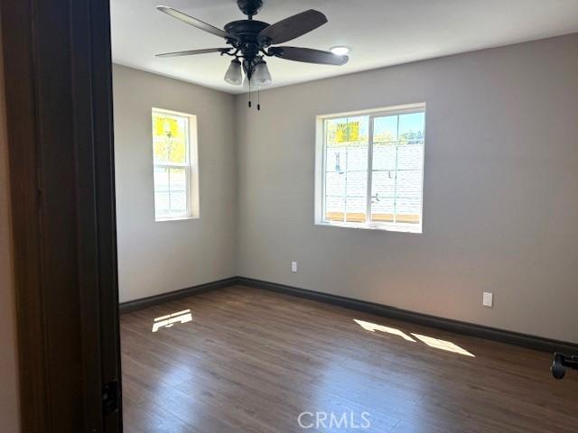 373 Davos Dr, Crestline, CA 92325 - unfurnished room with plenty of natural light, baseboards, and wood finished floors