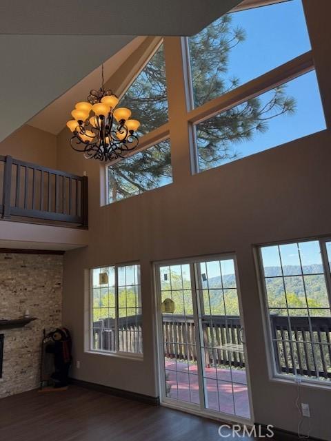 373 Davos Dr, Crestline, CA 92325 - entryway featuring an inviting chandelier, plenty of natural light, a towering ceiling, and wood finished floors