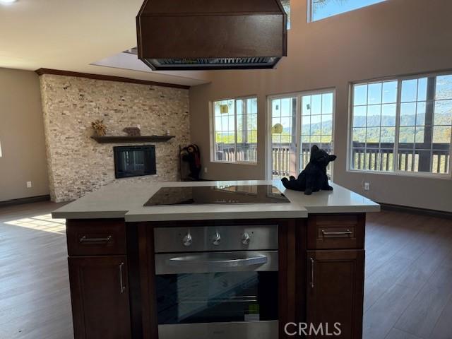 373 Davos Dr, Crestline, CA 92325 - kitchen featuring black electric cooktop, light countertops, wood finished floors, and oven