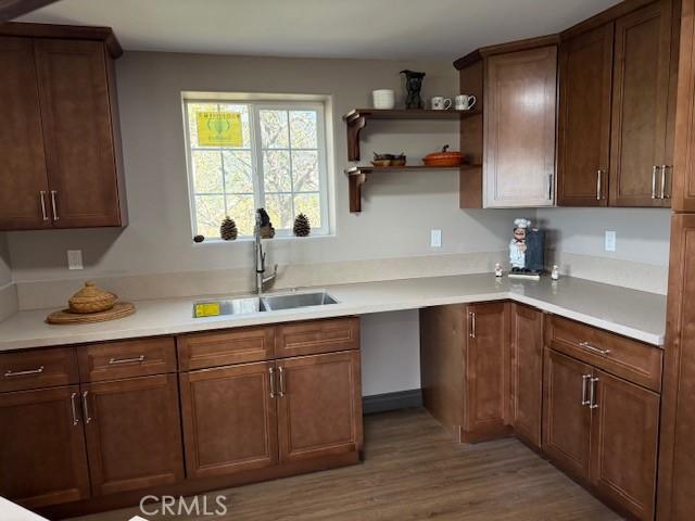 373 Davos Dr, Crestline, CA 92325 - kitchen featuring light countertops, a sink, and wood finished floors