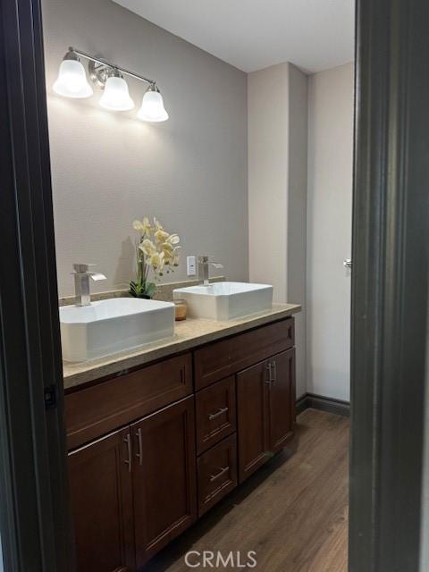 373 Davos Dr, Crestline, CA 92325 - bathroom featuring a sink, double vanity, and wood finished floors