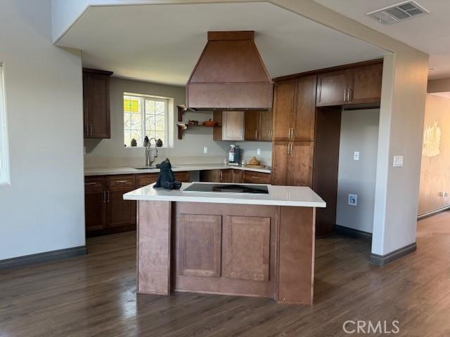 373 Davos Dr, Crestline, CA 92325 - kitchen with visible vents, black electric stovetop, dark wood-style floors, a center island, and a sink