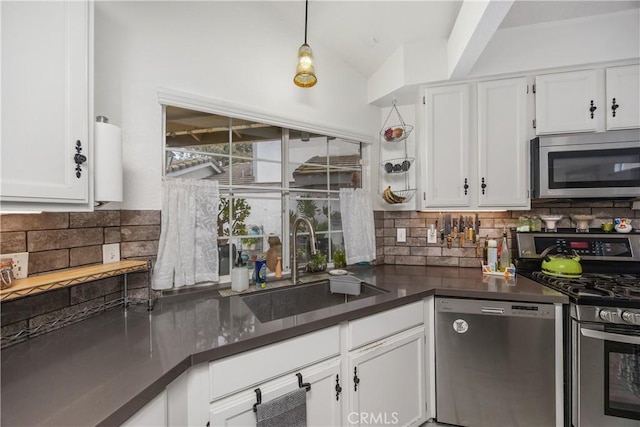 42065 Kaffirboom Ct, Temecula, CA 92591 - kitchen featuring appliances with stainless steel finishes, a sink, dark countertops, white cabinets, and vaulted ceiling