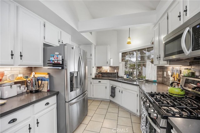 42065 Kaffirboom Ct, Temecula, CA 92591 - kitchen with appliances with stainless steel finishes, a sink, dark countertops, tasteful backsplash, and lofted ceiling