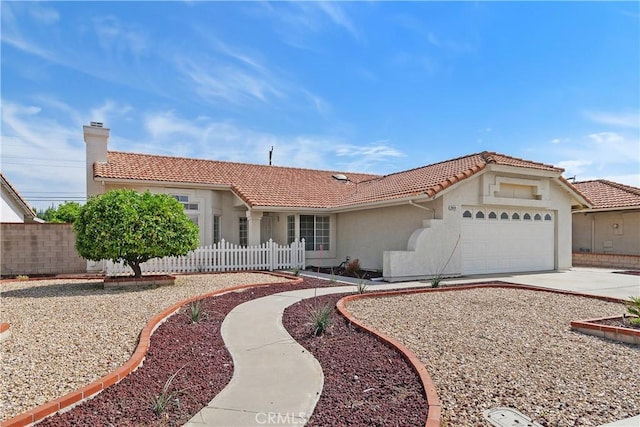 ranch-style home featuring stucco siding, fence, and a tiled roof