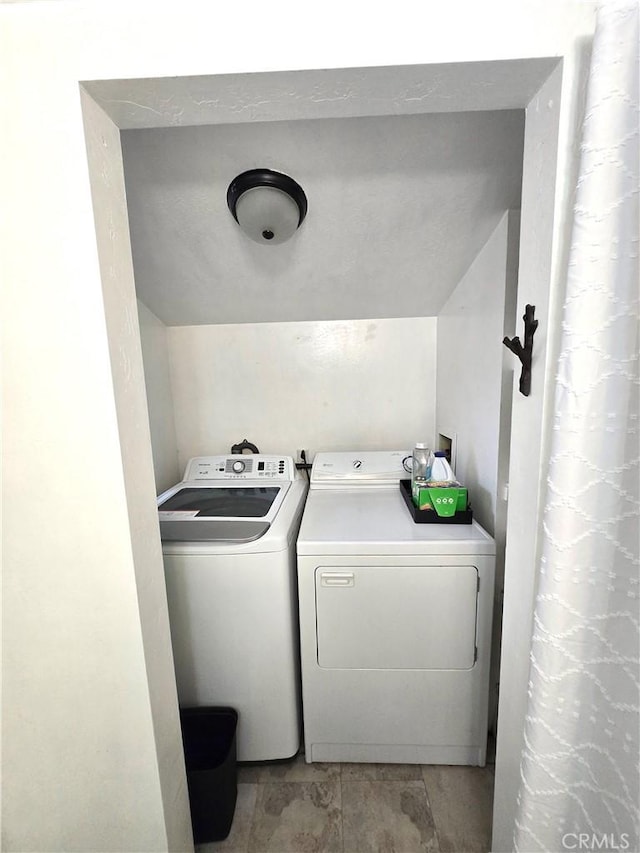 laundry room with separate washer and dryer and laundry area