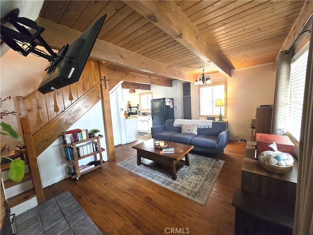 living room featuring beamed ceiling, a notable chandelier, dark wood finished floors, and wood ceiling