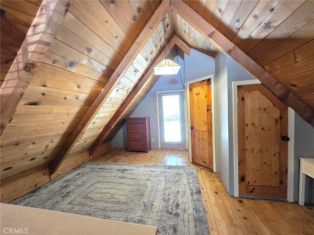 bonus room featuring lofted ceiling with beams, wooden ceiling, and hardwood / wood-style flooring