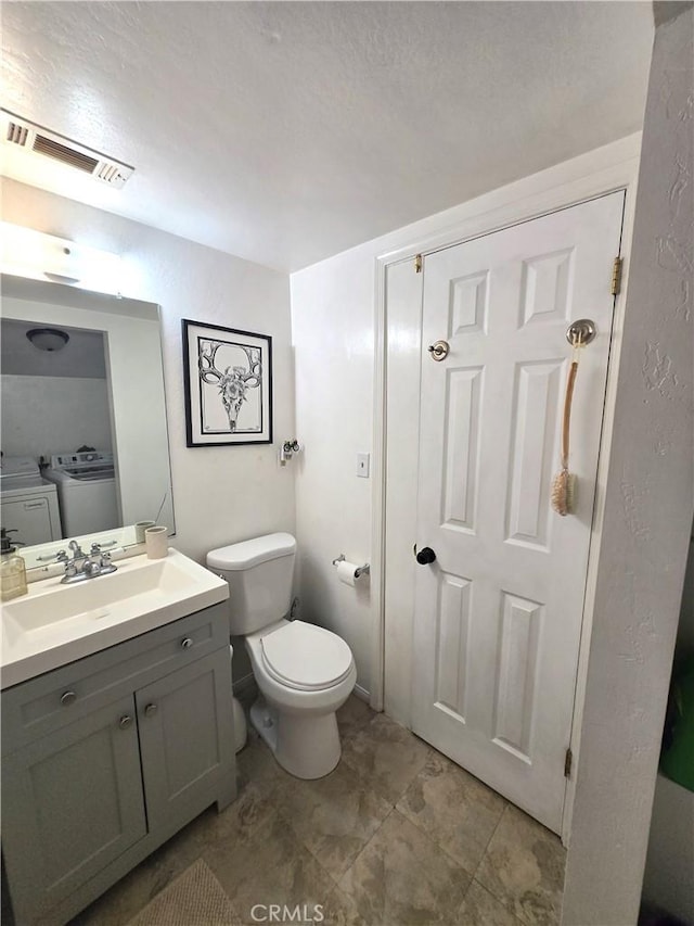 143 Cedar Ln, Sugarloaf, CA 92386 - half bathroom featuring separate washer and dryer, vanity, and toilet