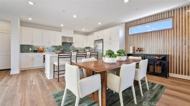 dining room with recessed lighting and light wood-style flooring