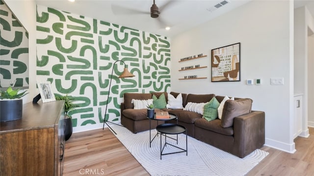 living room with visible vents, light wood-style floors, baseboards, recessed lighting, and a ceiling fan