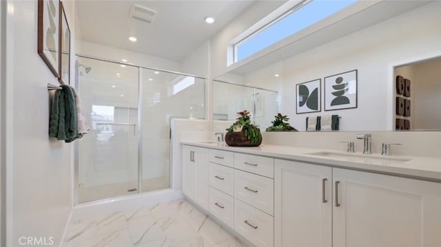 full bath with double vanity, visible vents, a stall shower, a sink, and marble finish floor