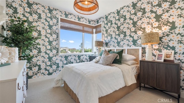 bedroom with baseboards, wallpapered walls, and carpet floors