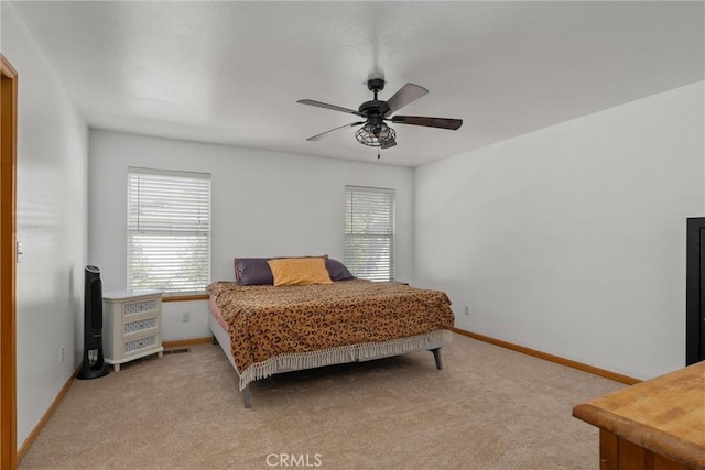 bedroom featuring baseboards, ceiling fan, and light carpet