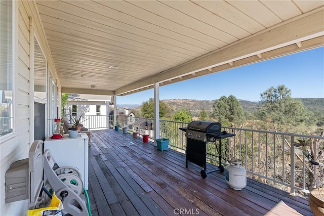 wooden deck with a mountain view and grilling area