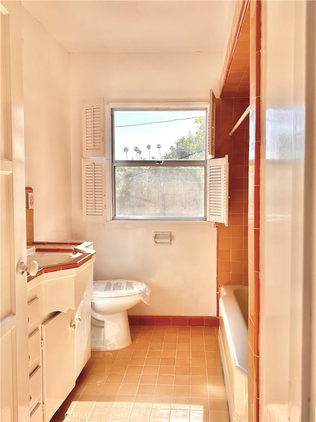 full bath with a bath, a shower, tile patterned floors, vanity, and toilet
