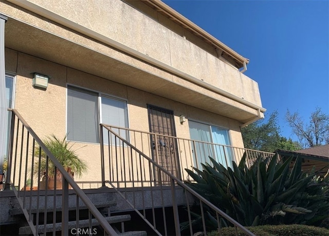 property entrance with stucco siding