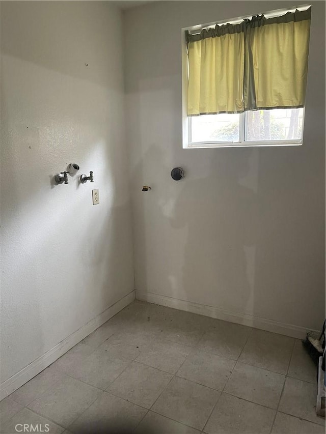 spare room featuring baseboards