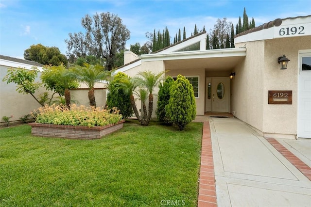 6192 Sierra Siena Rd, Irvine, CA 92603 - view of exterior entry featuring a lawn and stucco siding