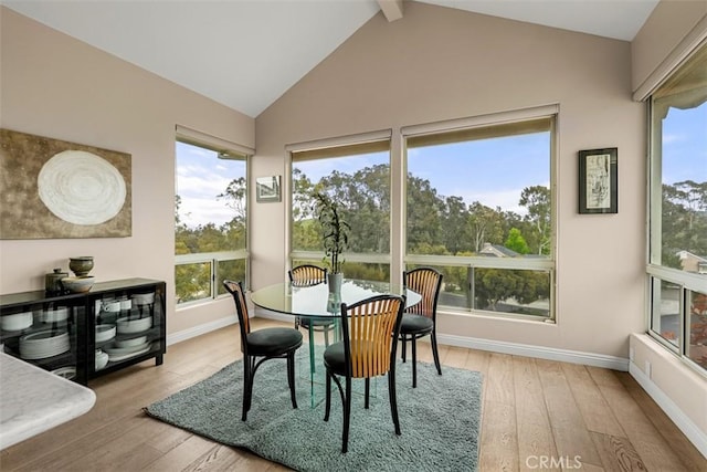 20 Delphinus Unit 20, Irvine, CA 92603 - dining space featuring baseboards, high vaulted ceiling, beam ceiling, and hardwood / wood-style floors