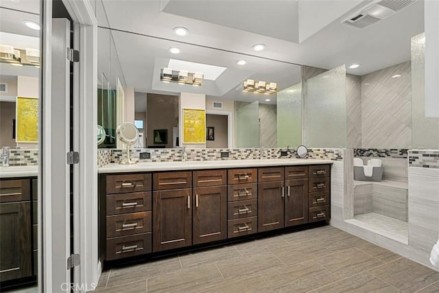 20 Delphinus Unit 20, Irvine, CA 92603 - bathroom featuring visible vents, decorative backsplash, vanity, recessed lighting, and a walk in shower
