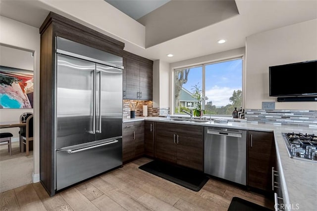 20 Delphinus Unit 20, Irvine, CA 92603 - kitchen with light countertops, stainless steel appliances, dark brown cabinetry, and a sink