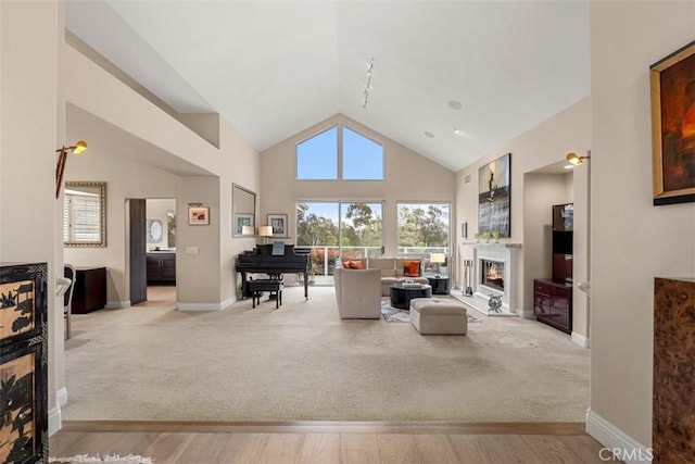 20 Delphinus Unit 20, Irvine, CA 92603 - living area featuring a healthy amount of sunlight, baseboards, a warm lit fireplace, and wood finished floors