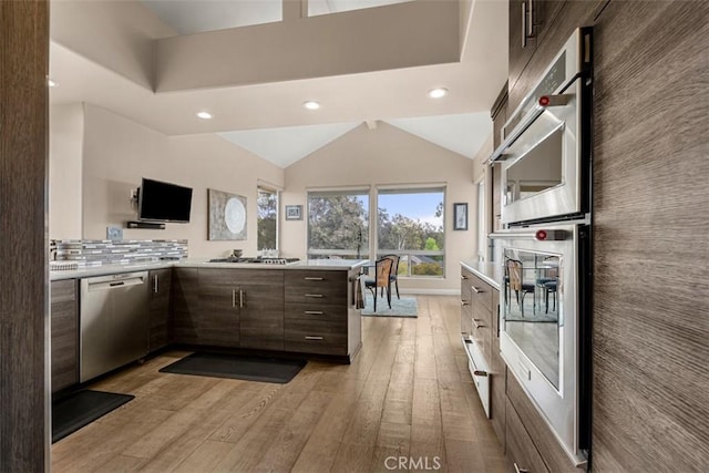 20 Delphinus Unit 20, Irvine, CA 92603 - kitchen featuring light countertops, appliances with stainless steel finishes, light wood-style floors, and dark brown cabinets