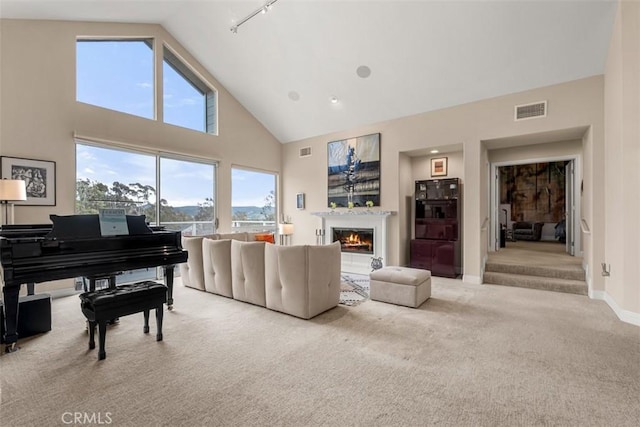 20 Delphinus Unit 20, Irvine, CA 92603 - carpeted living area featuring a glass covered fireplace, high vaulted ceiling, baseboards, and visible vents