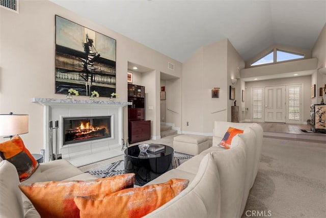 20 Delphinus Unit 20, Irvine, CA 92603 - living room with high vaulted ceiling, visible vents, stairway, and a fireplace