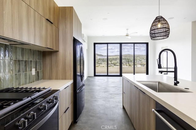 kitchen with range with gas stovetop, freestanding refrigerator, modern cabinets, a sink, and dishwasher