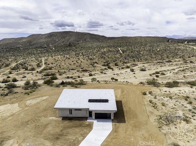 birds eye view of property with a mountain view and view of desert
