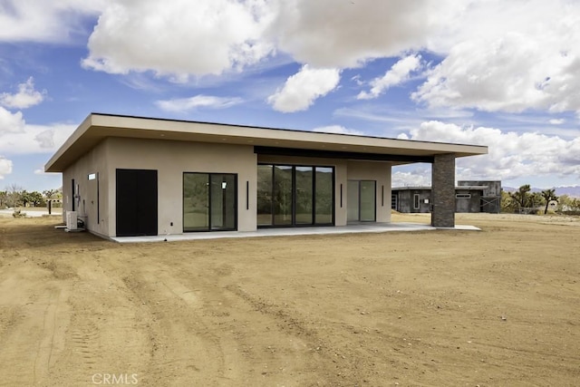back of property featuring a patio and stucco siding