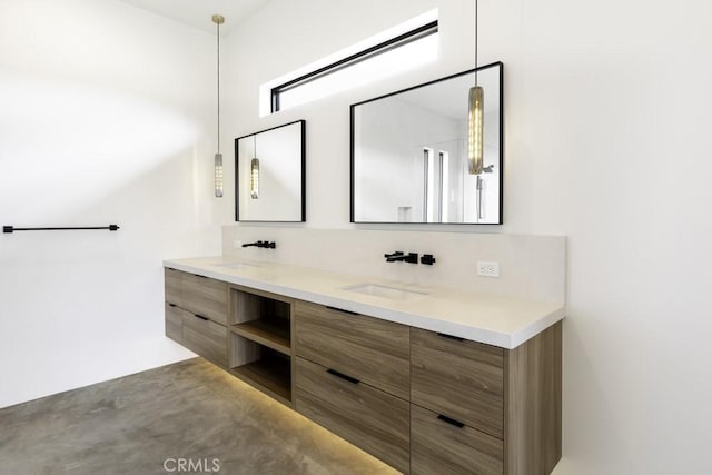 bathroom with double vanity, a sink, and concrete flooring