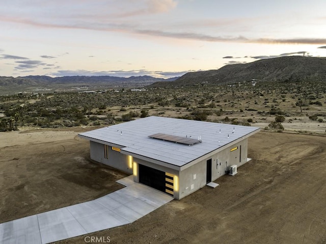 birds eye view of property with a mountain view and view of desert
